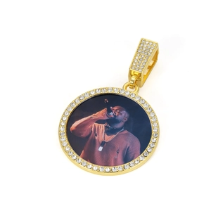 Detailed shot of a gold-plated hip-hop pendant with CZ stones and custom photo center