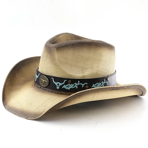 Detail of leather band with turquoise bull embroidery and bronze badge on straw cowboy hat