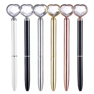 Sleek metal ballpoint pens with large heart crystal toppers in multiple metallic colors