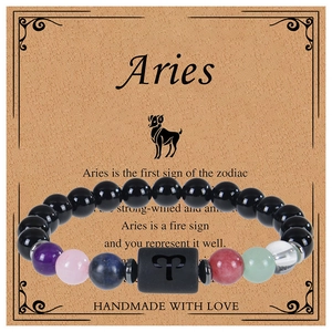 Close-up of Aries zodiac bracelet with black obsidian and multicolor crystal beads on card