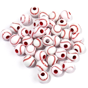 Macro shot of white acrylic baseball beads with red stitching for DIY jewelry making