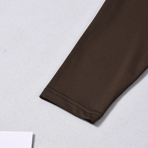 Detail of the cuff with double-needle stitching on the brown bodycon dress fabric