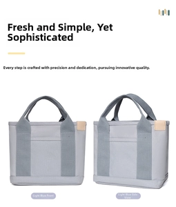 Detail of light blue canvas tote bag featuring durable straps and leather patch accents