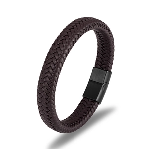 Detail of dark brown braided leather bracelet featuring a black magnetic metal clasp