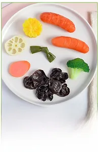 Close-up of artificial PVC vegetable mix including broccoli and lotus root in a bowl