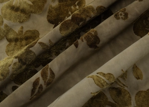Detailed macro view of dark brown tie-dye fabric with embossed floral velvet texture