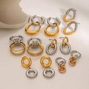 Minimalist stainless steel hoop earrings collection in gold and silver finish on stone