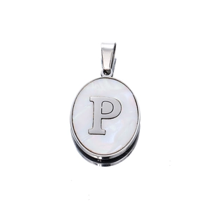 Macro detail of oval stainless steel pendant with letter P on white mother of pearl