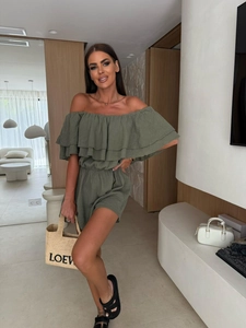 Detail of ruffle neckline and textured fabric on this olive green off-shoulder romper