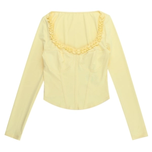 Flat lay of pale yellow long sleeve top with square neck, ruffle trim and corset waist