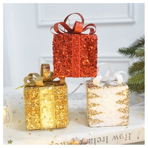 Close-up of sparkling Christmas gift box ornaments with glitter and festive silk bows