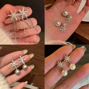 Silver snowflake earrings set with pearls and zircons in four elegant tassel styles