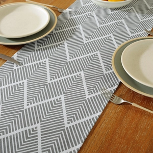 Nordic gray ripple cotton linen table runner with geometric pattern on wooden dining table