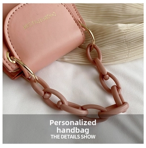 Detailed close-up of a pink jelly bag with resin chain strap and gold hardware accents
