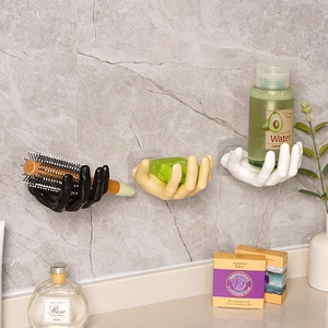 Creative hand-shaped wall hooks in black, beige, and white for bathroom storage