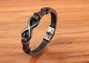 Detailed close-up of brown braided leather strap and black stainless steel magnetic clasp