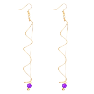 Detail of gold spiral wire earrings featuring purple pearl accents and drop design