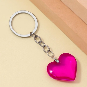 Close-up of a 3D translucent pink resin heart keychain with a polished silver metal ring