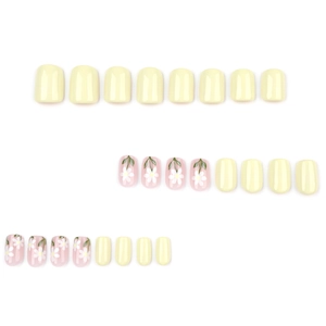 Short square press-on nails with yellow and daisy floral patterns on white background