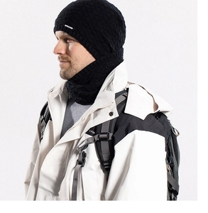 Close-up of black knitted beanie and neck warmer with detailed thermal fabric texture