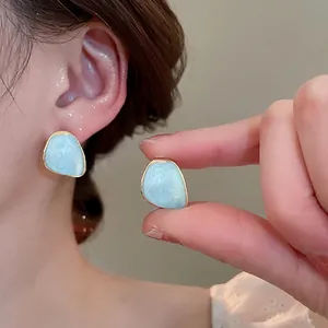 Light blue marble tulip stud earrings with elegant gold trim and fringe detail