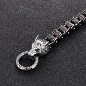 Macro detail of retro wolf head clasp and mechanical steel chain bracelet for men