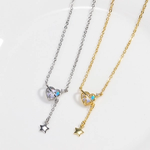 Detail of heart pendants with colorful stones and dangling star charms in gold and silver
