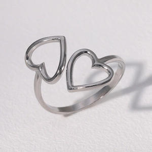 Detail view of silver heart-shaped adjustable open ring with a polished metallic finish