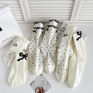 Breathable off-white crew socks with black polka dots, heart patterns and silk bows