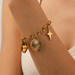 Gold vintage bracelet featuring leopard print, sun moon relief, and star pendants