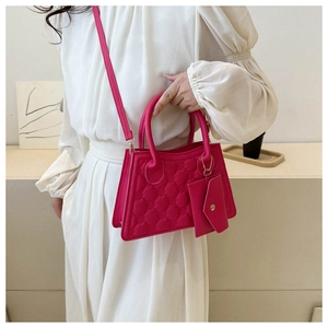 Pink quilted square handbag with detachable crossbody strap and matching small pouch