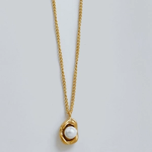 Minimalist stainless steel necklace with irregular gold metal and pearl pendant on white background