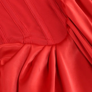 Close-up of elegant red dress showing shiny satin and delicate mesh fabric texture