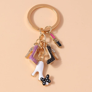 Detail of keychain featuring glitter heels, polka dot bow shoe, and pink lipstick charms