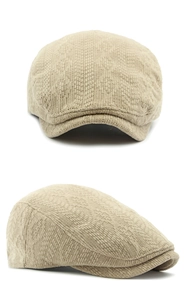 Close-up of khaki knitted newsboy hat showing detailed geometric textured fabric patterns