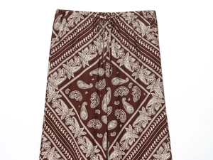 Detail view of paisley print pants with elastic waistband and adjustable drawstring