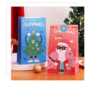 Detailed view of red and blue Christmas gift bags with Santa Claus and tree illustrations