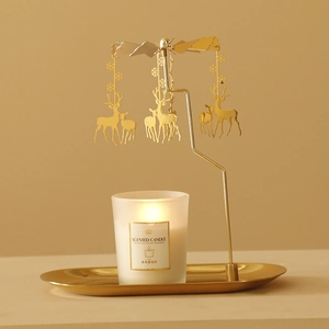 Golden rotating reindeer carousel candle holder with tray and scented candle set