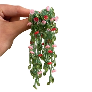 Handmade forest style silver needle earrings with green leaf and flower glass tassels.