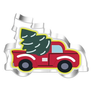 Detail of Christmas cookie cutter in red truck with tree shape made of stainless steel