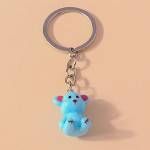 Detailed view of a sky blue 3D resin bear keychain with silver metal ring and chain