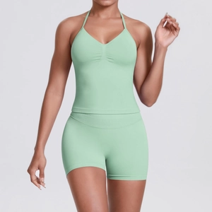 Detail view of seamless mint green yoga set featuring V-neck tank top and biker shorts
