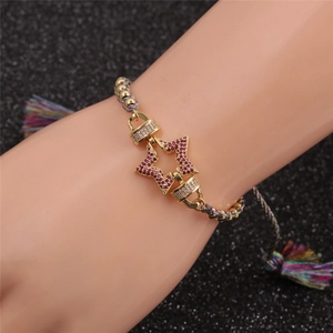 Détail d'un bracelet ajustable avec pendentif étoile et zircon rouge sur cordon tressé