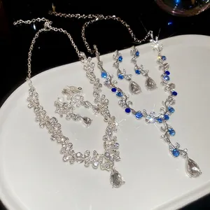 Elegant floral teardrop pendant necklace and earring set with shimmering zircon stones