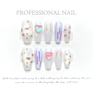 Detail of long ballerina press-on nails with lavender dots and 3D heart charms