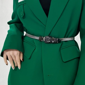 Close-up of a silver metal spring waist chain with square buckle on a green blazer