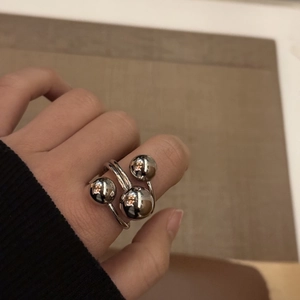 Detailed view of women's stainless steel multi-layer ring with polished silver spheres