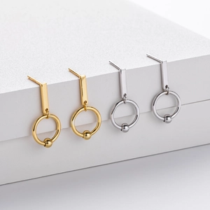 Detail view of gold and silver S925 sterling silver geometric double hoop drop earrings