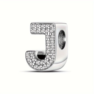 Macro shot of silver letter J charm with pavé cubic zirconia for DIY bracelets