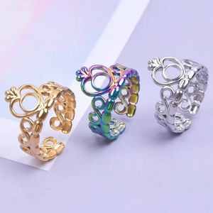 Three crown-style hollow filigree rings in gold, rainbow, and silver adjustable finishes